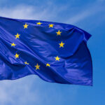 Flag Of The European Union Waving In The Wind On Flagpole Against The Sky With Clouds, Banner